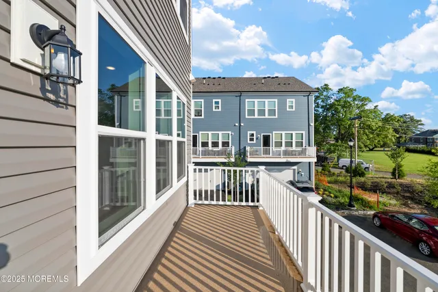 a large kitchen with stainless steel appliances a large counter top a stove and a refrigerator