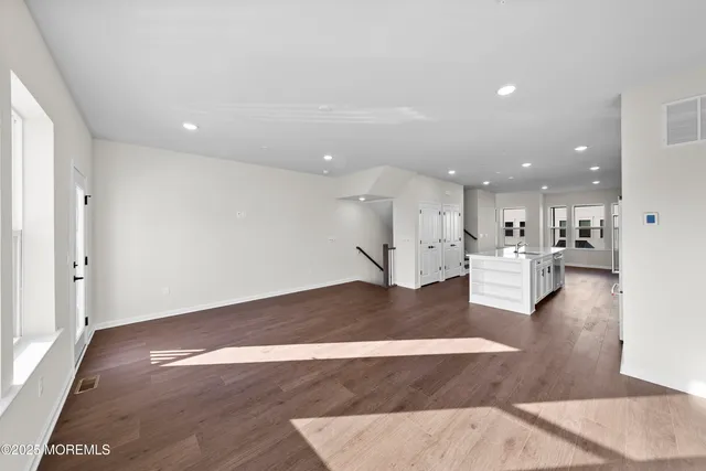 a view of a room with wooden floor
