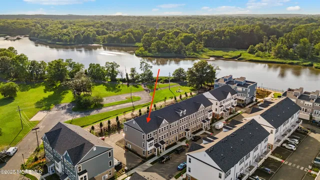 an aerial view of residential houses with outdoor space and river