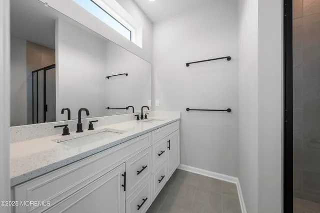 a view of an empty room with wooden floor and windows