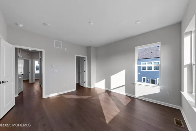a view of a room with wooden floor and windows