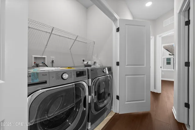 a kitchen with stainless steel appliances a refrigerator a stove a sink and white cabinets