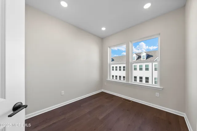 a view of a street that has couple of cars parked on the road