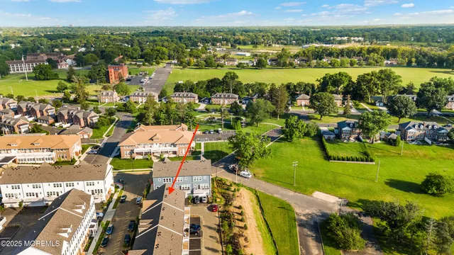 an aerial view of residential building and lake