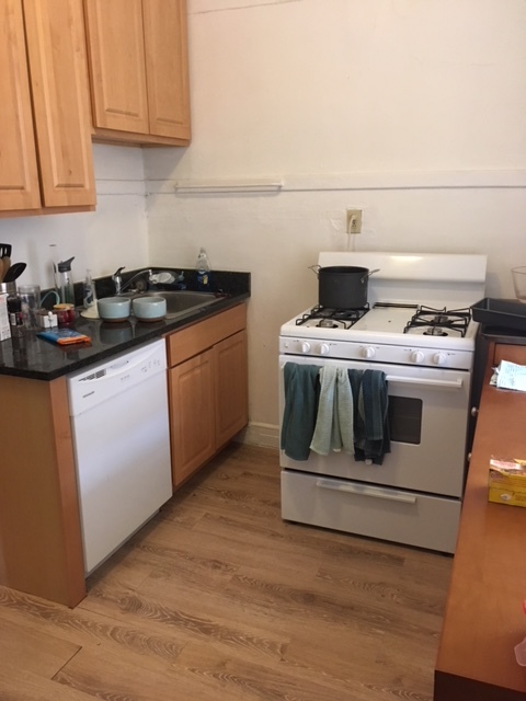 638 West Roscoe Street, Unit 3 Chicago, IL 60657 - Photo 8 of 13 a white stove top oven sitting inside of a kitchen