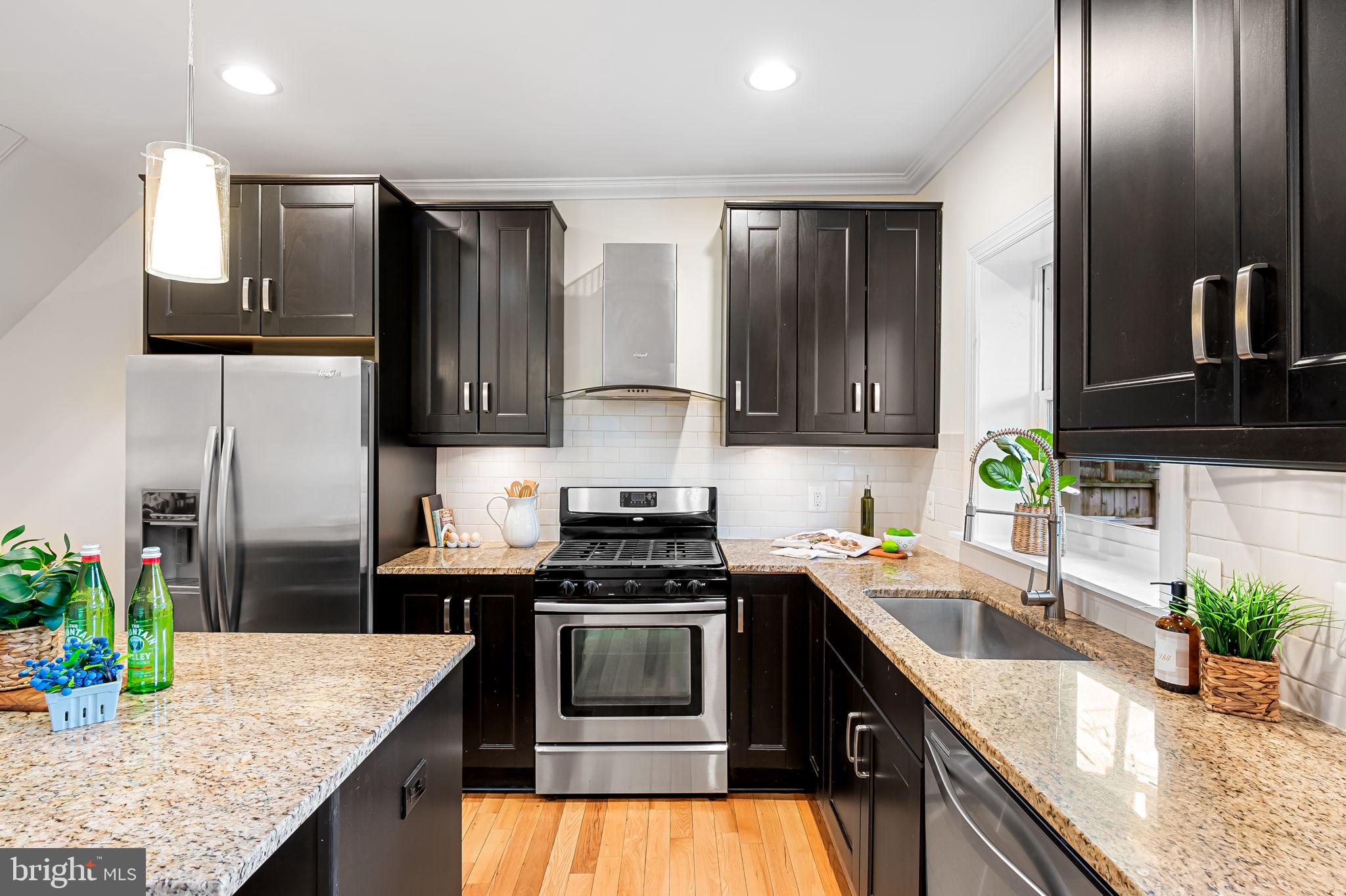 116 Rochester Place Baltimore, MD 21224 - Photo 13 of 45 a kitchen with granite countertop stainless steel appliances and sink