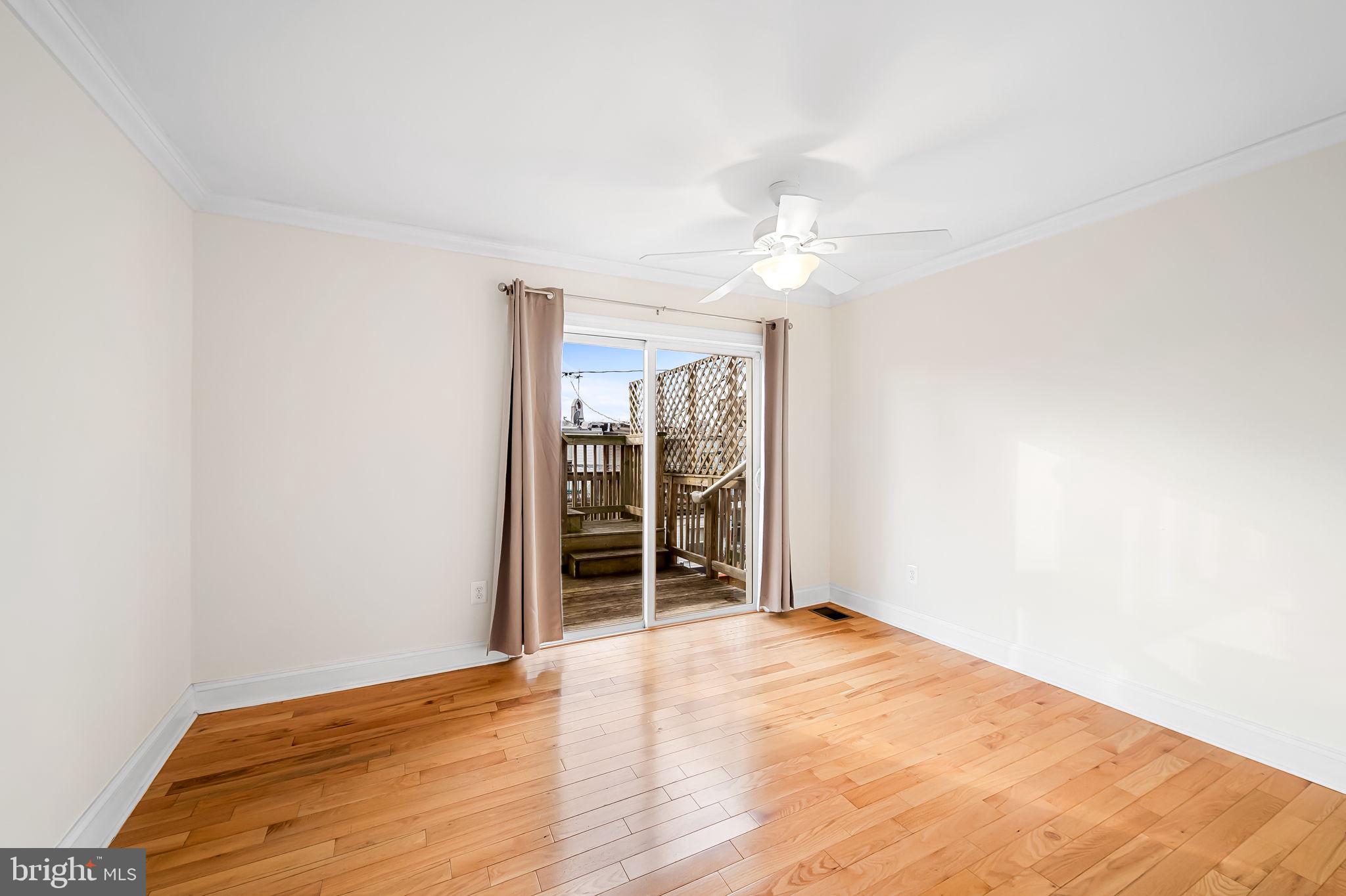 116 Rochester Place Baltimore, MD 21224 - Photo 27 of 45 wooden floor in an empty room with a window