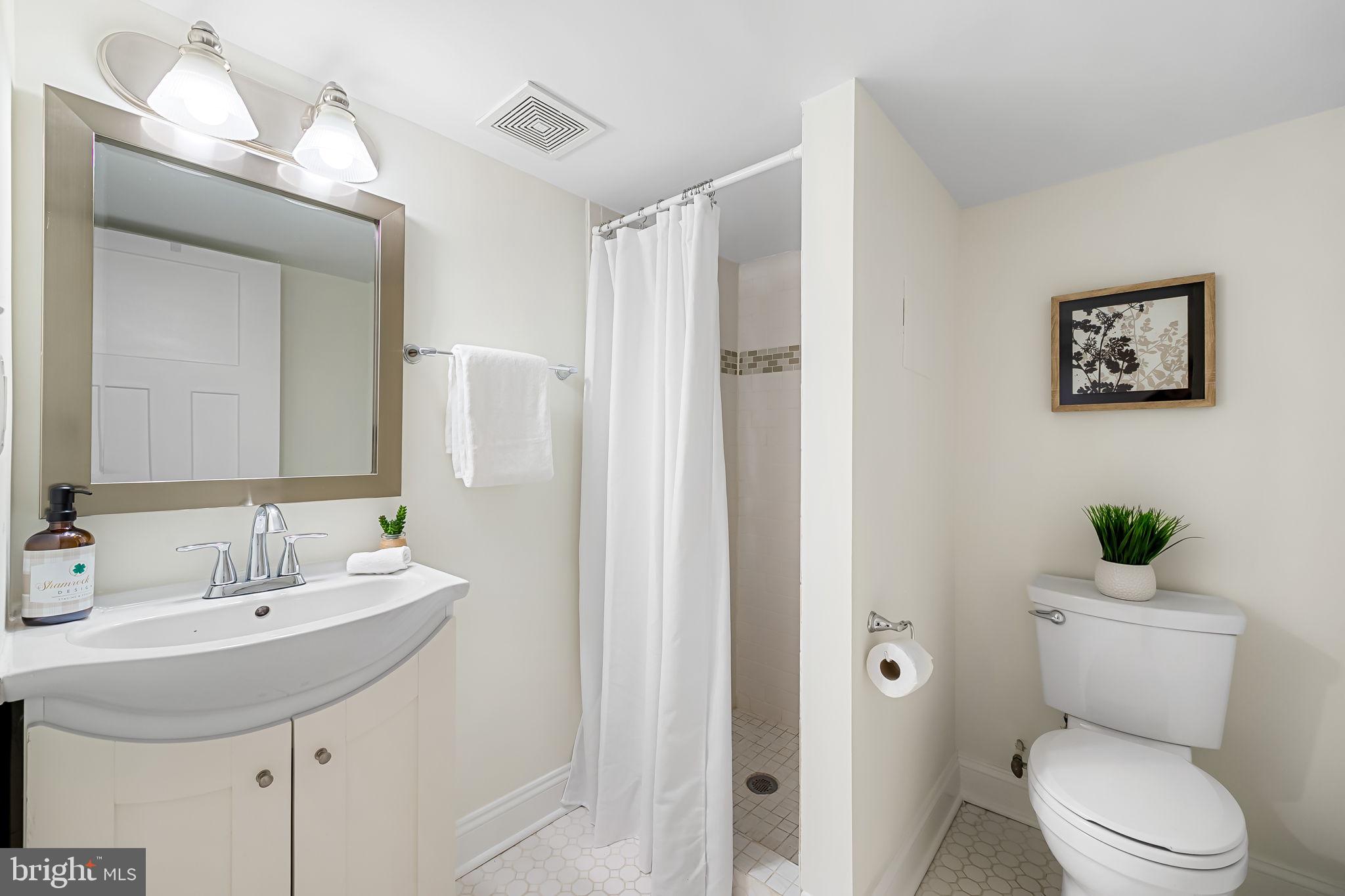 116 Rochester Place Baltimore, MD 21224 - Photo 37 of 45 a bathroom with a toilet sink and mirror