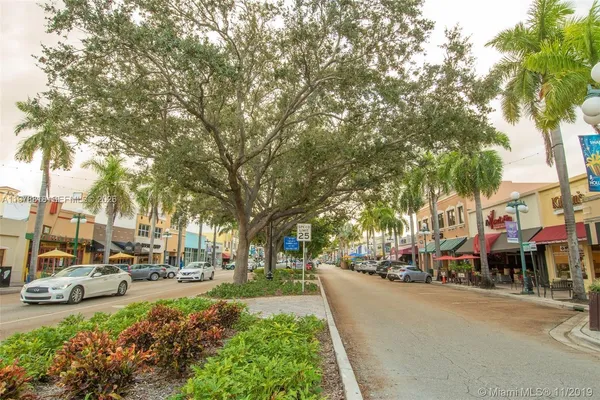 a front view of a building with trees