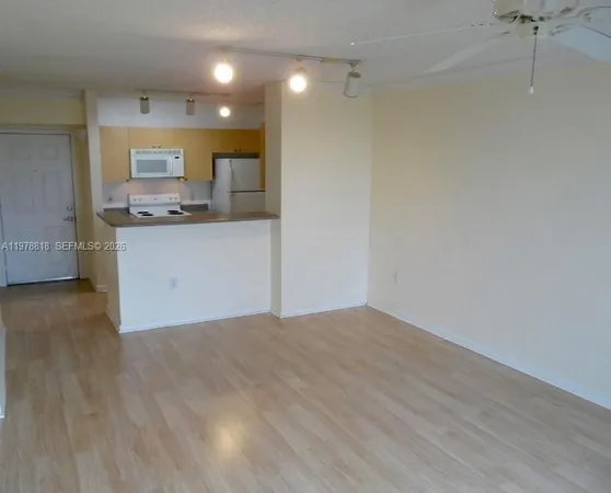 a view of kitchen and wooden floor