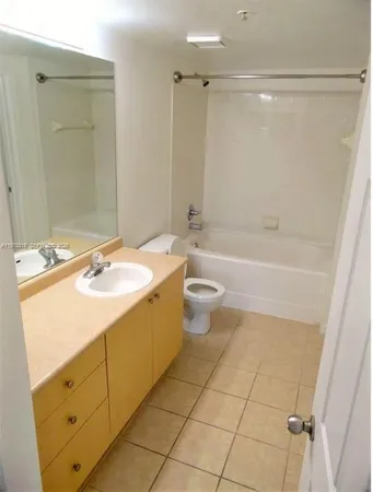 a bathroom with a sink a toilet a mirror and a bathtub