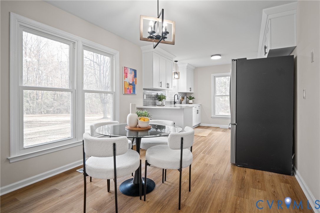 15101 Loving Union Road Disputanta, VA 23842 - Photo 14 of 50 a view of a dining room with furniture window and wooden floor