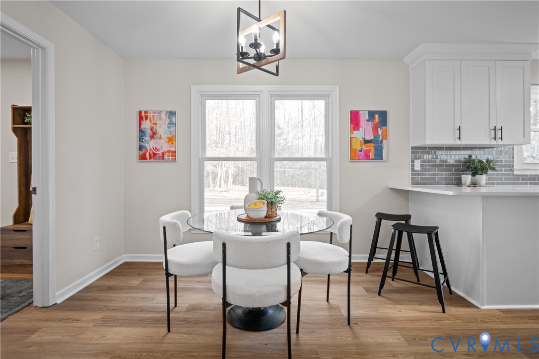 15101 Loving Union Road Disputanta, VA 23842 - Photo 15 of 50 a dining room with furniture a rug and a window