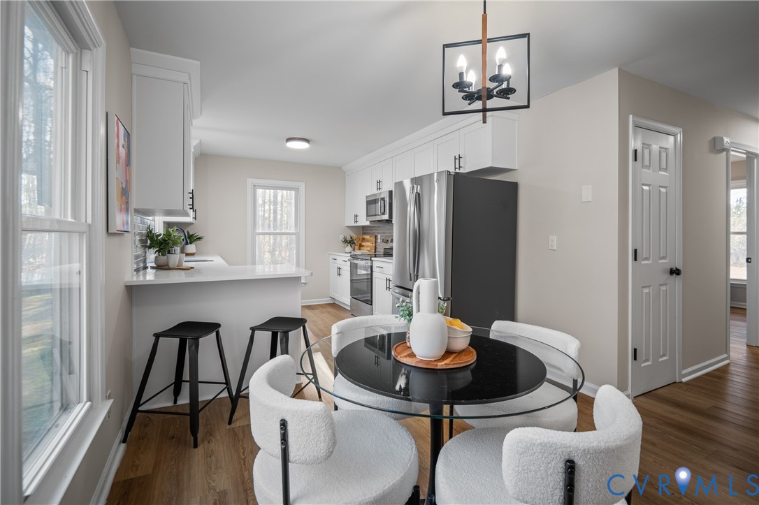 15101 Loving Union Road Disputanta, VA 23842 - Photo 16 of 50 a view of a dining room with furniture window and wooden floor