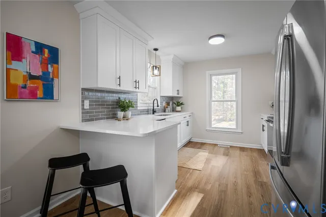 a view of a hallway view with wooden floor and staircase