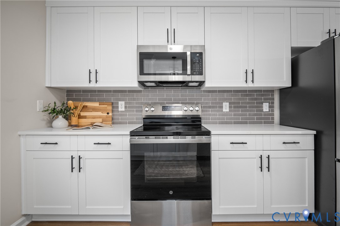 15101 Loving Union Road Disputanta, VA 23842 - Photo 19 of 50 a kitchen with stainless steel appliances granite countertop a stove and a microwave