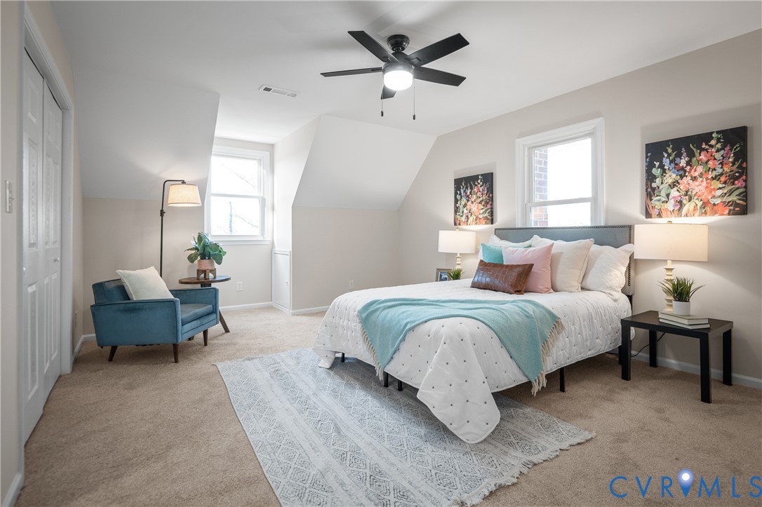 15101 Loving Union Road Disputanta, VA 23842 - Photo 40 of 50 a bedroom with a bed and a chandelier