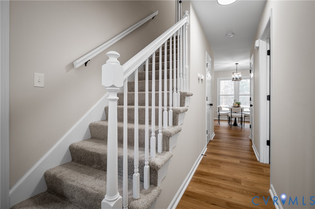 15101 Loving Union Road Disputanta, VA 23842 - Photo 7 of 50 a view of a hallway with wooden floor and stairs
