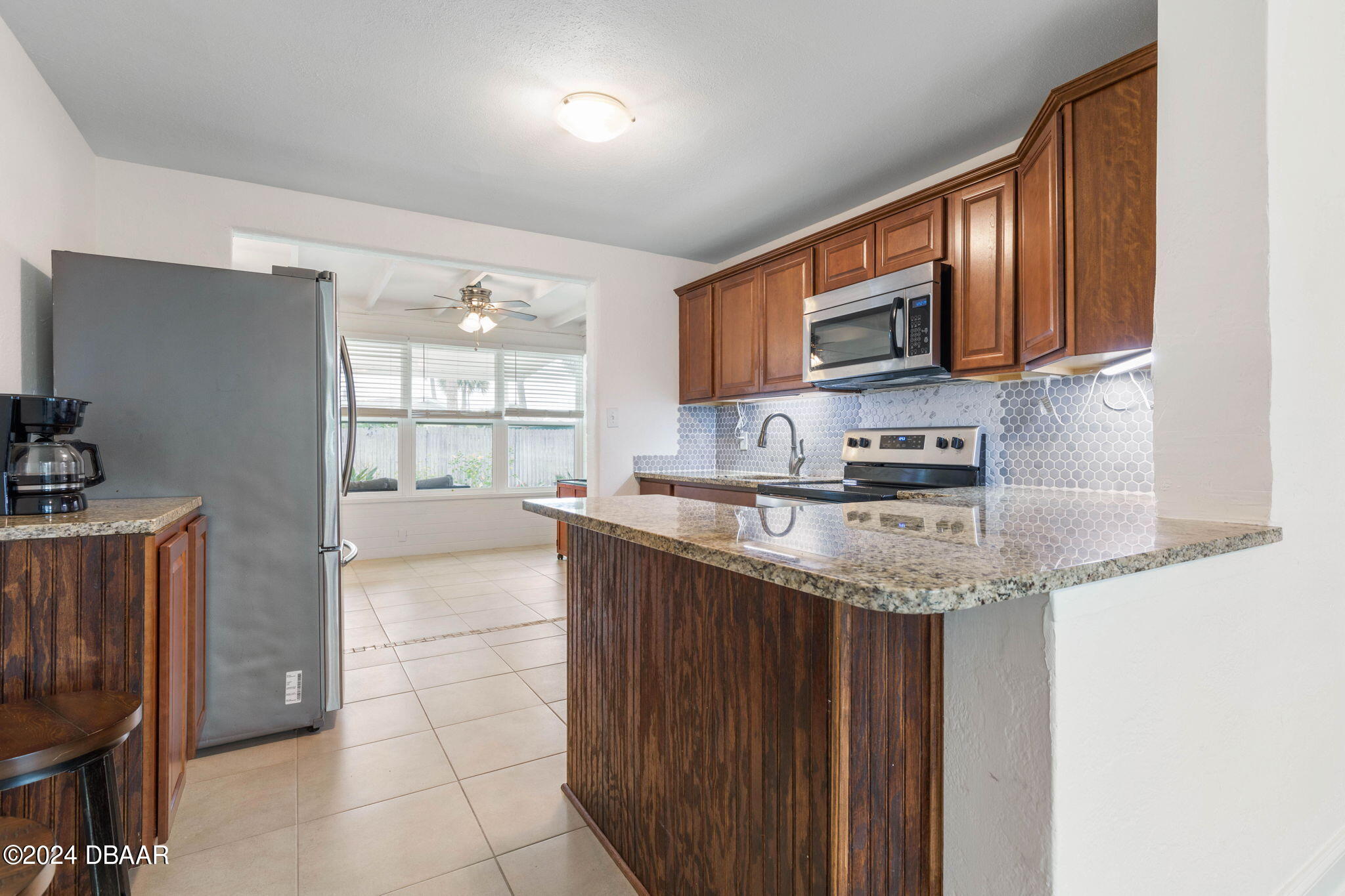 9 Palm Drive Ormond Beach, FL 32176 - Photo 11 of 47 a kitchen with stainless steel appliances granite countertop a stove a sink and a microwave