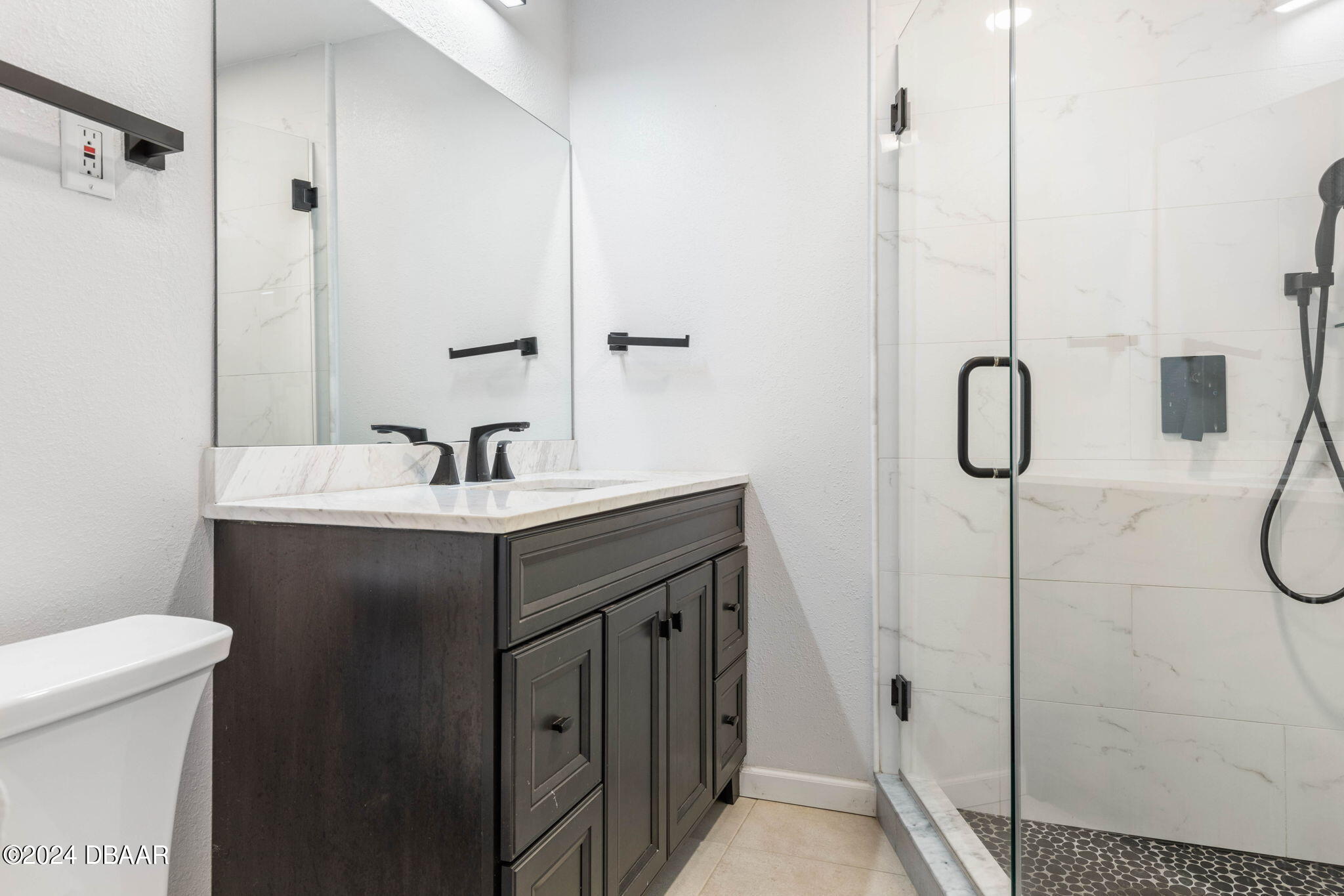 9 Palm Drive Ormond Beach, FL 32176 - Photo 23 of 47 a bathroom with a sink and mirror