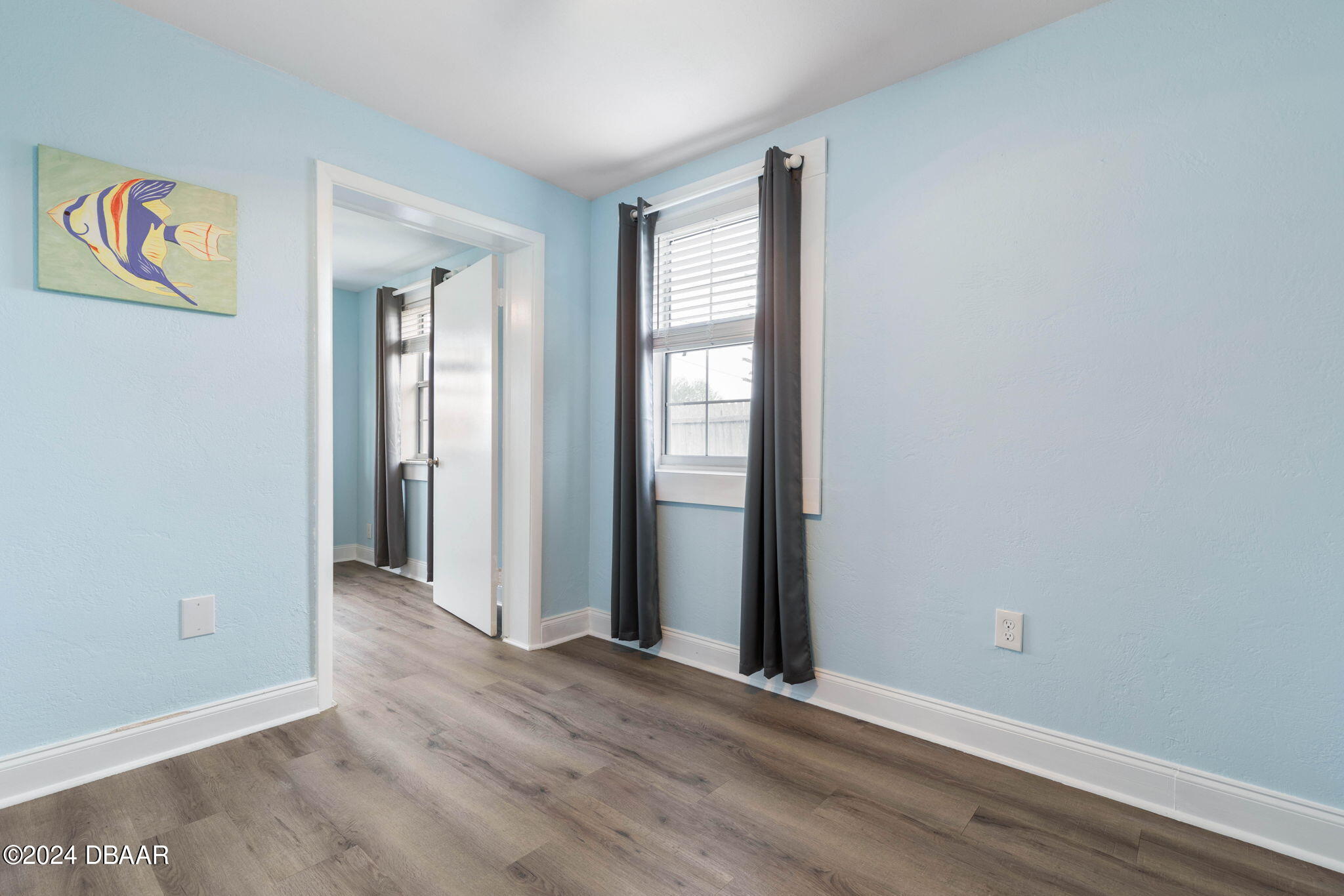 9 Palm Drive Ormond Beach, FL 32176 - Photo 26 of 47 an empty room with wooden floor and windows