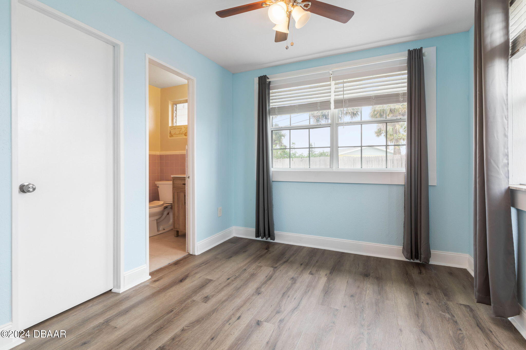 9 Palm Drive Ormond Beach, FL 32176 - Photo 28 of 47 an empty room with wooden floor chandelier and windows