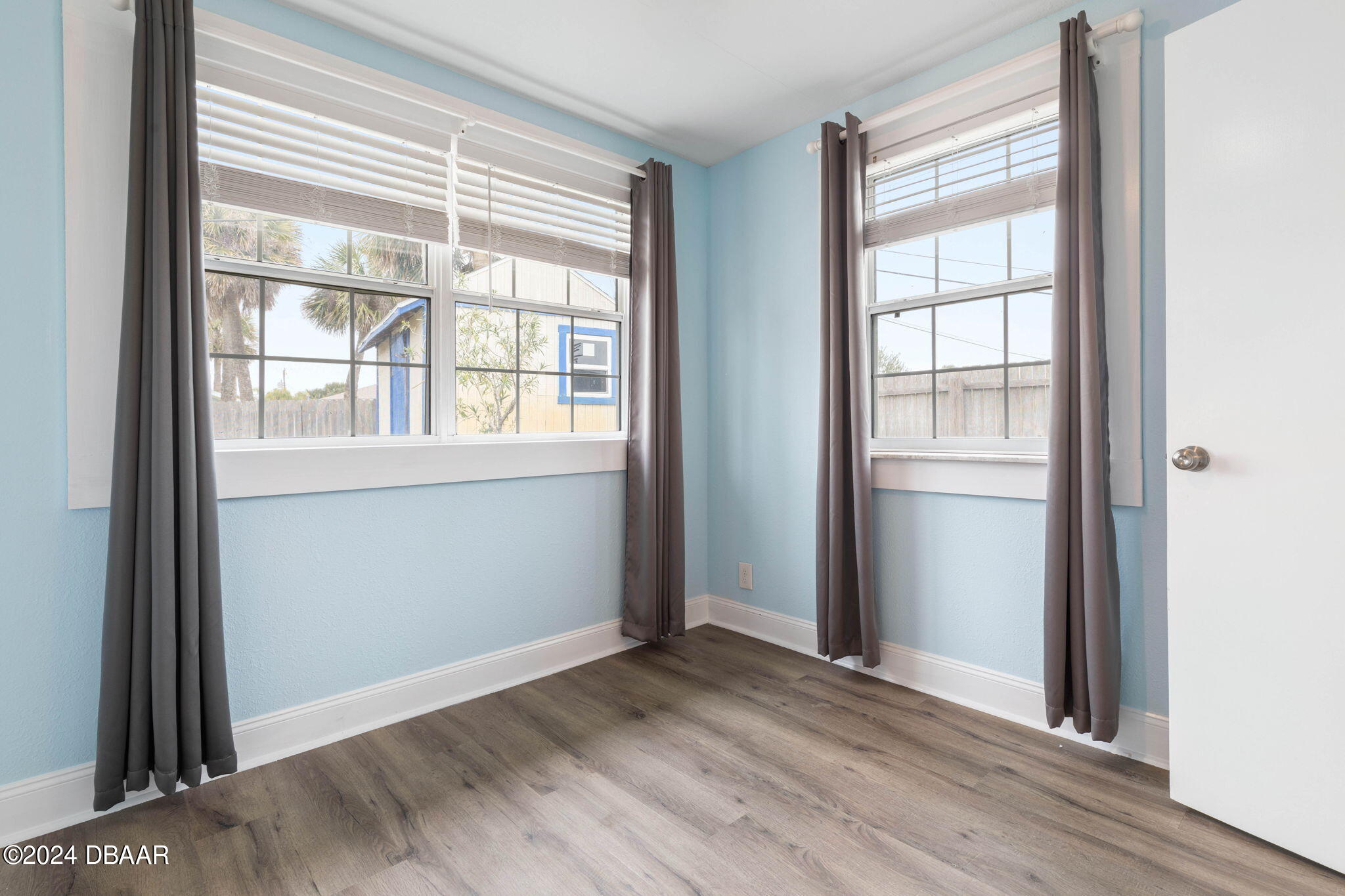 9 Palm Drive Ormond Beach, FL 32176 - Photo 29 of 47 an empty room with wooden floor and windows