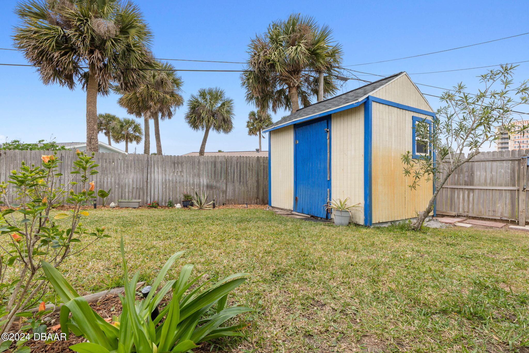 9 Palm Drive Ormond Beach, FL 32176 - Photo 38 of 47 a view of a yard in front of a house with a large tree