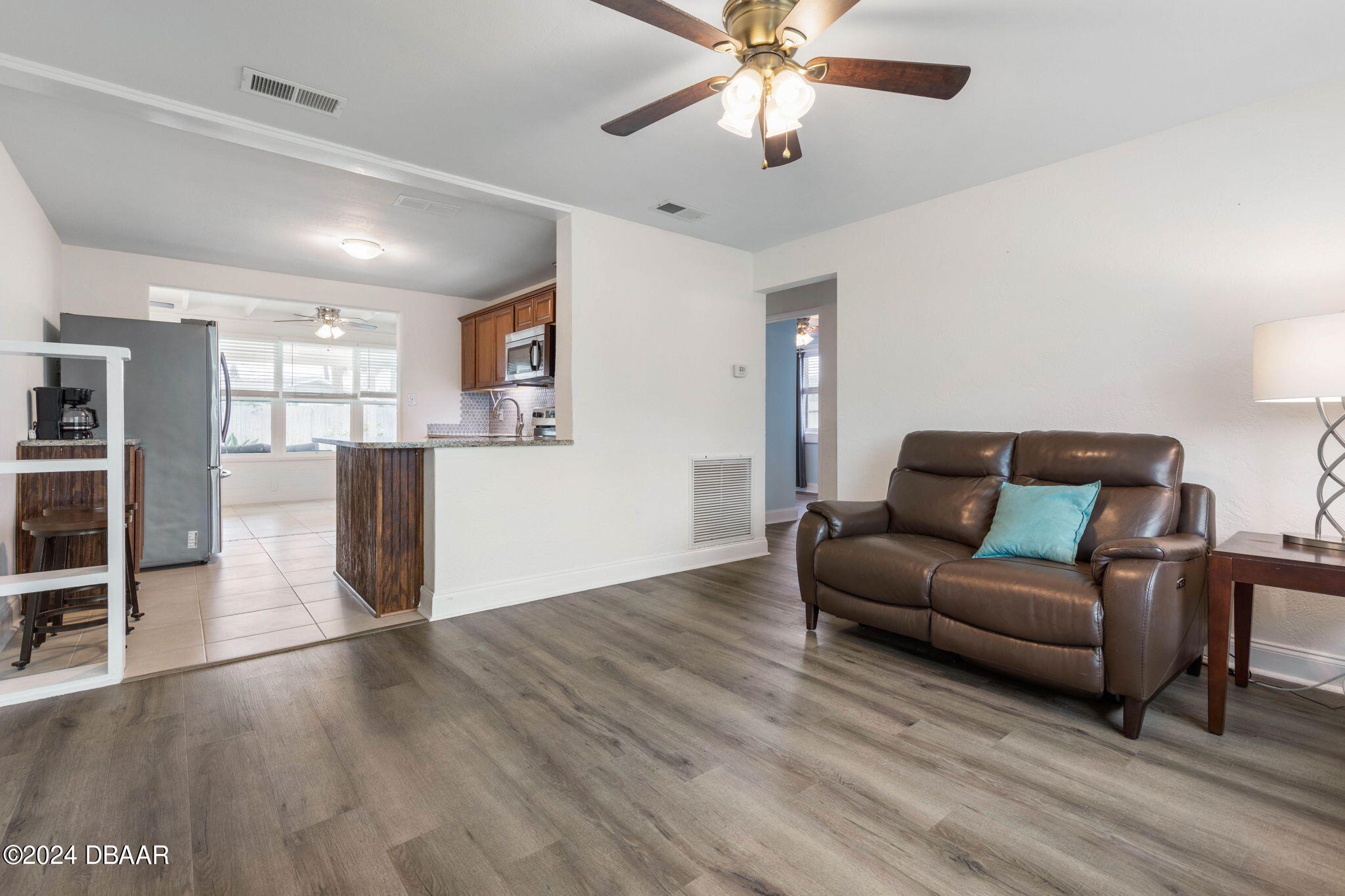 9 Palm Drive Ormond Beach, FL 32176 - Photo 10 of 47 a living room with furniture and kitchen view