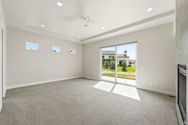 496 North Farmhouse Way, Unit 11 Midway, UT 84049 - Photo 23 of 50 Spacious room featuring a tray ceiling with recessed lighting, a ceiling fan, and light gray wall-to-wall carpeting