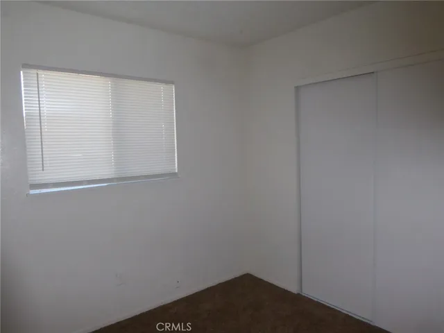 a view of small space with wooden floor and closet