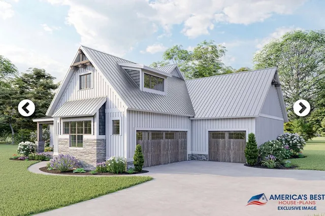 a front view of a house with a garden and yard