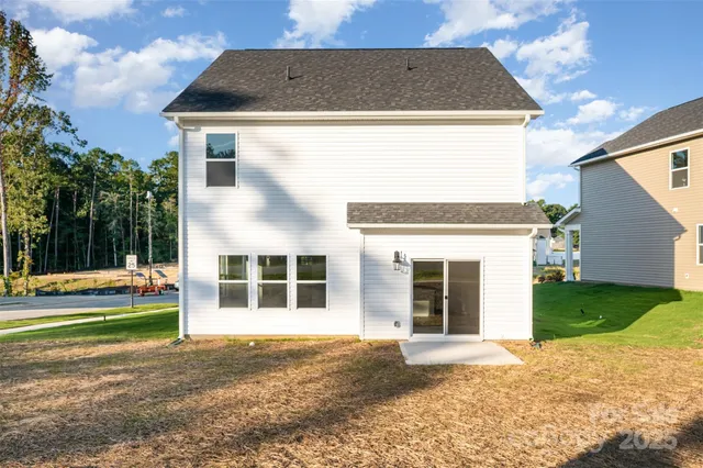 a view of a white house with a yard