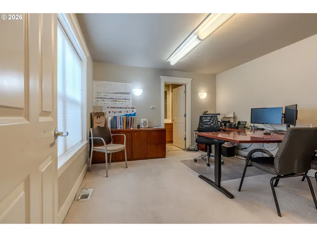 a view of a workspace with furniture