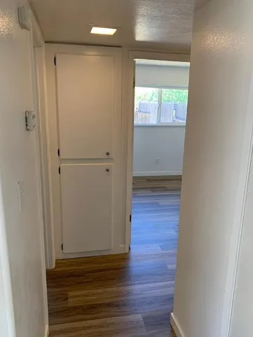 a view of empty room with wooden floor