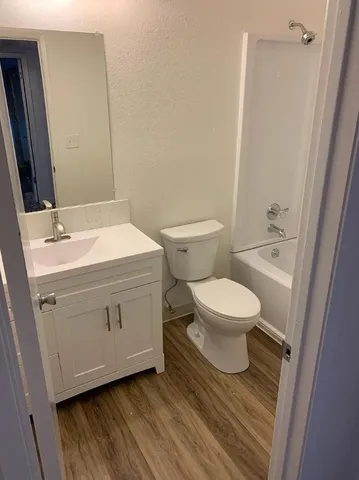 a white toilet sitting next to a bathroom sink