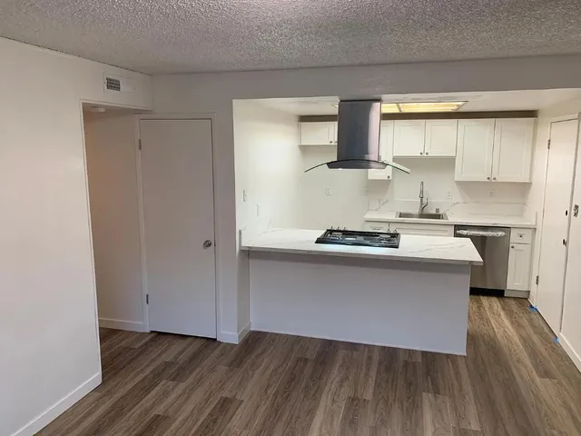 a kitchen with a refrigerator and window