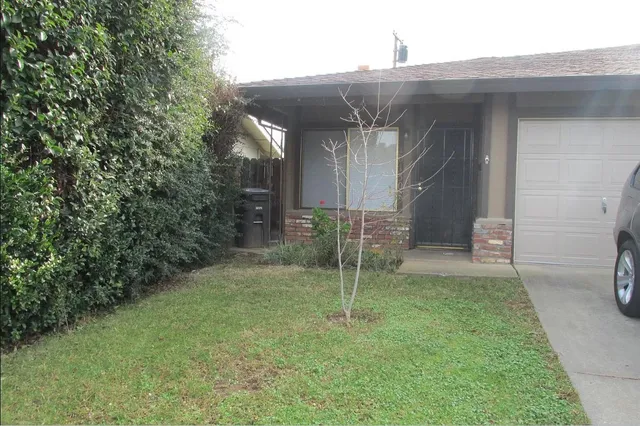 a view of an empty room with brick wall and a window