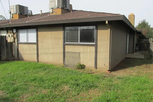 a view of a backyard with wooden fence