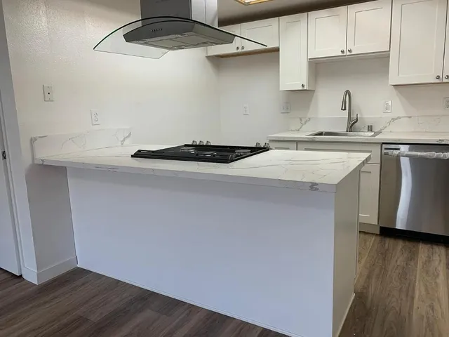 a kitchen with a sink a stove and cabinets