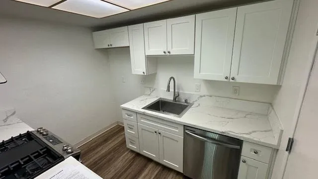a view of a room with wooden floor and entryway