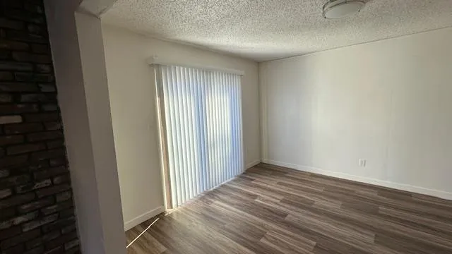 a view of a room with wooden floor and staircase