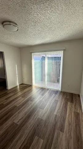 a view of a hardwood floor and staircase