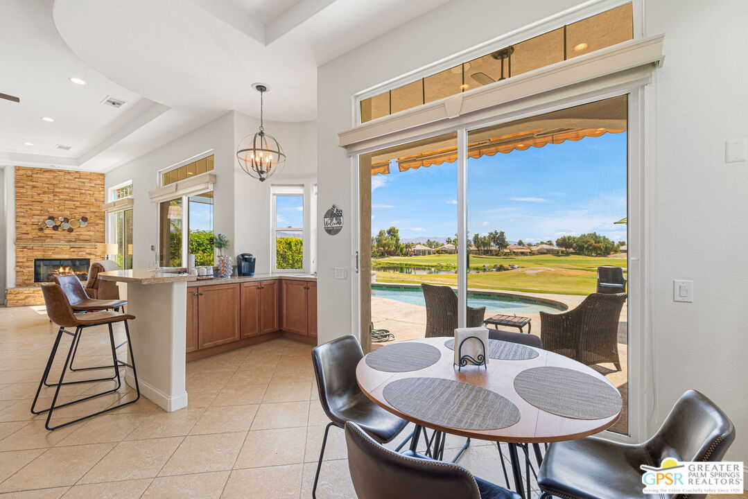 88 Vía Las Flores Rancho Mirage, CA 92270 - Photo 31 of 65 a dining room with furniture and a floor to ceiling window