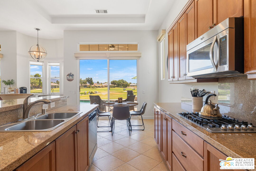 88 Vía Las Flores Rancho Mirage, CA 92270 - Photo 33 of 65 a kitchen with furniture a sink and a stove top oven