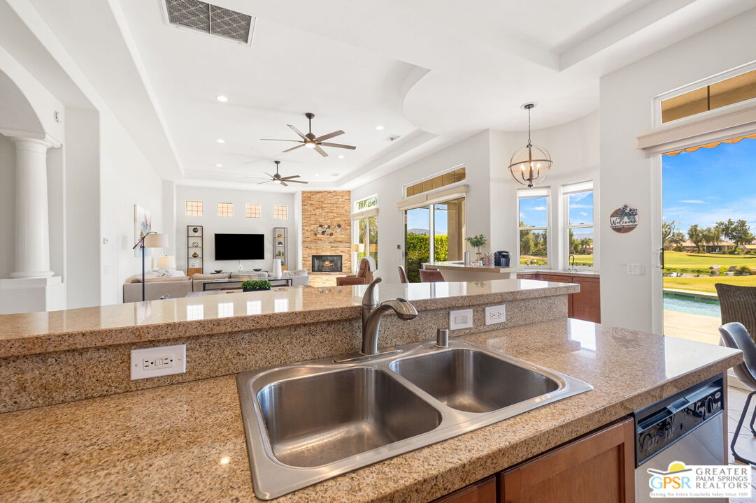 88 Vía Las Flores Rancho Mirage, CA 92270 - Photo 35 of 65 a kitchen with a sink and a refrigerator