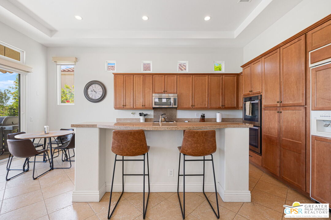 88 Vía Las Flores Rancho Mirage, CA 92270 - Photo 36 of 65 a kitchen with stainless steel appliances granite countertop a refrigerator and a stove top oven