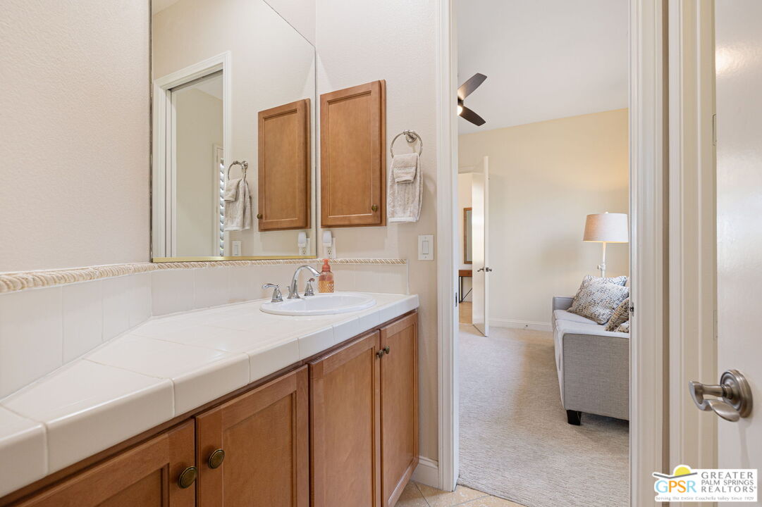 88 Vía Las Flores Rancho Mirage, CA 92270 - Photo 40 of 65 a bathroom with a sink a mirror and a shower