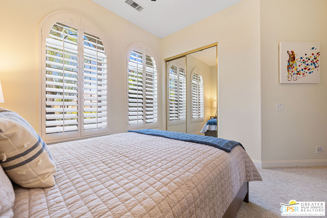 88 Vía Las Flores Rancho Mirage, CA 92270 - Photo 43 of 65 a bedroom with a bed and next to a window