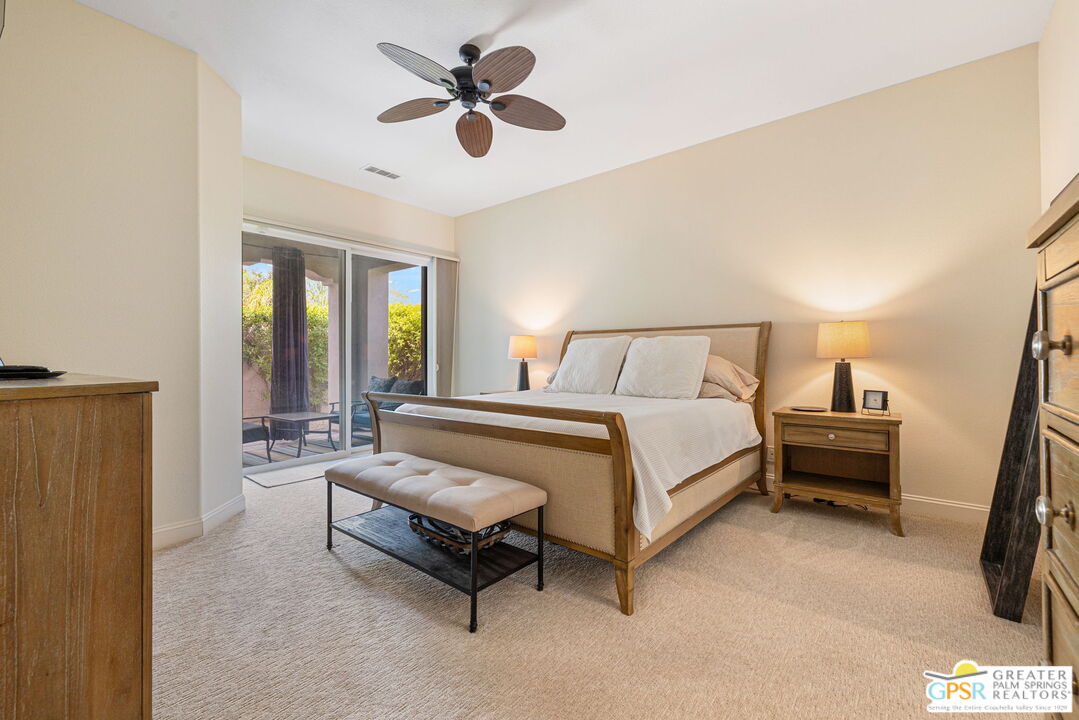 88 Vía Las Flores Rancho Mirage, CA 92270 - Photo 47 of 65 a spacious bedroom with a bed and a chandelier